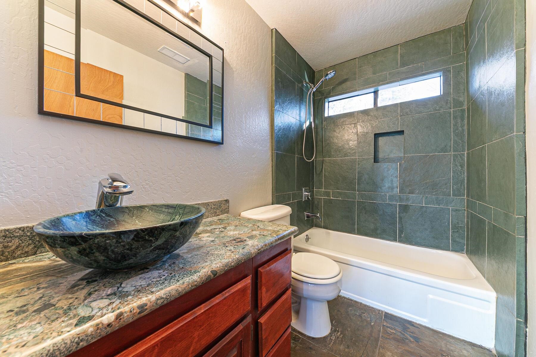 10806 Manchester Drive Truckee, CA 96161 - Photo 25 of 28 a bathroom with a granite countertop sink a toilet and bathtub