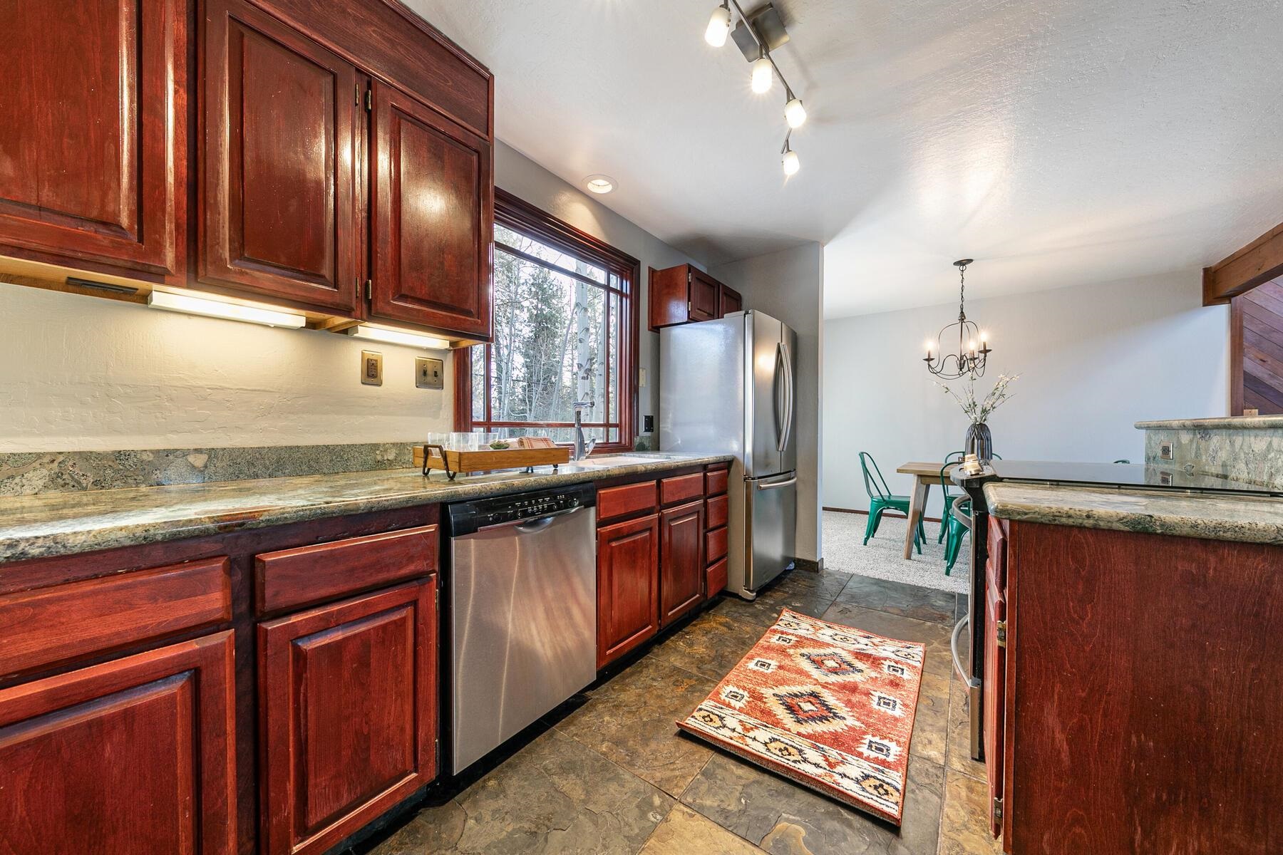 10806 Manchester Drive Truckee, CA 96161 - Photo 7 of 28 a large kitchen with granite countertop lots of counter top space and stainless steel appliances
