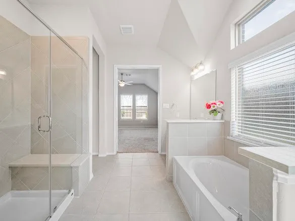 a spacious bathroom with a bathtub and sink