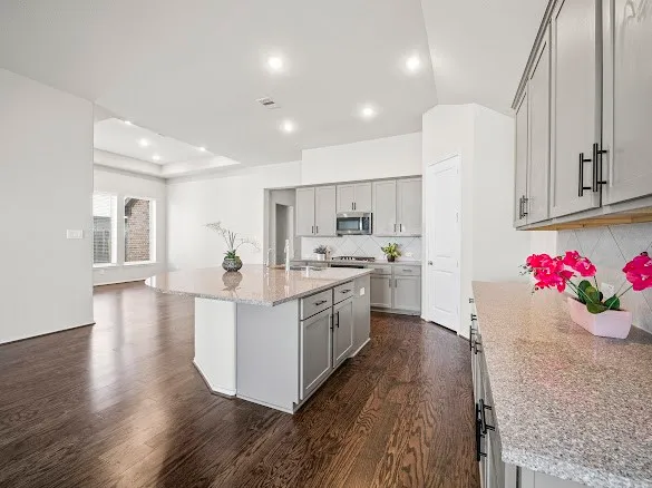 a kitchen with sink cabinets and wooden floor