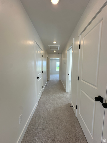 1225 West 500 South Logan, UT 84321 - Photo 28 of 39 Hallway with neutral carpeting, white walls, recessed lighting, and white paneled doors with black hardware