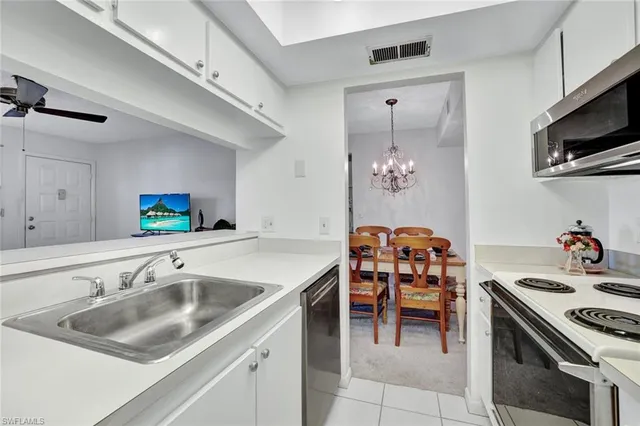 a kitchen with a sink appliances and cabinets