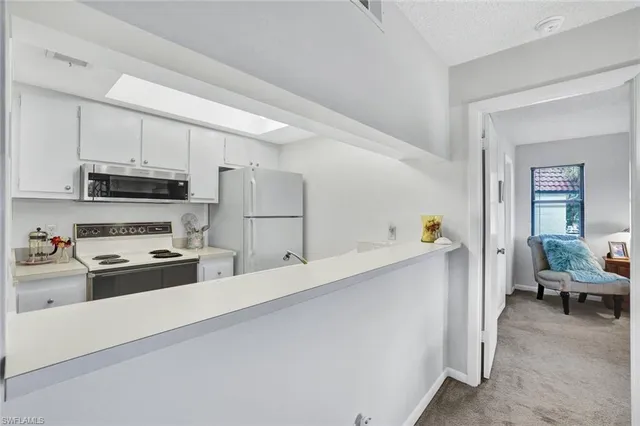 a kitchen with refrigerator a stove and a sink