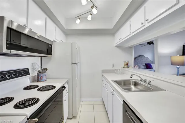 a kitchen that has a sink and a stove in it