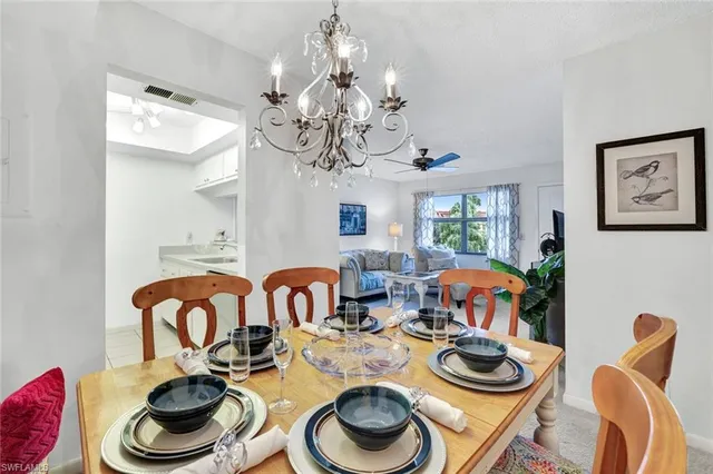 a dining room with furniture and a chandelier