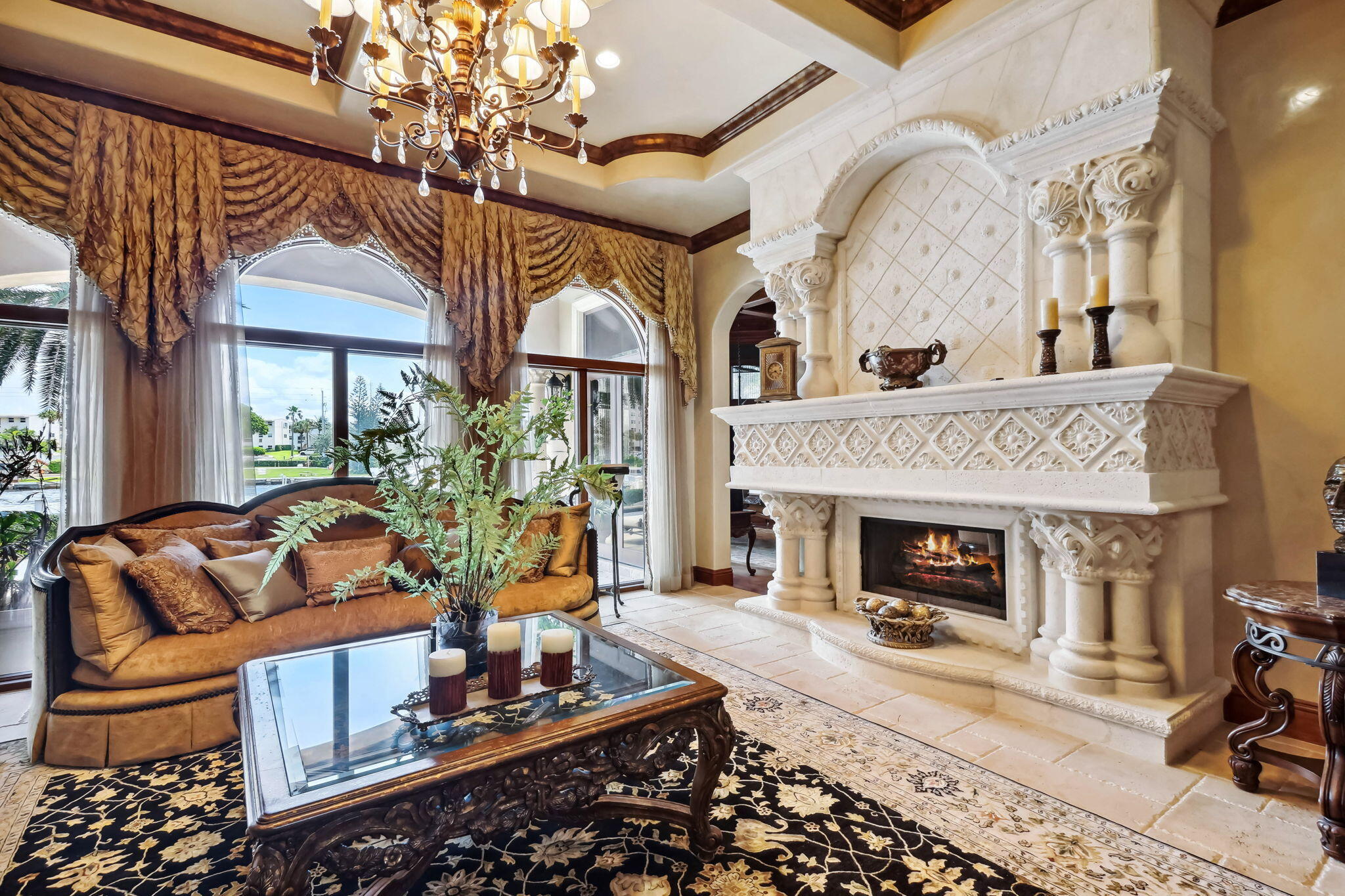 3870 Northeast 31st Avenue Lighthouse Point, FL 33064 - Photo 25 of 151 a living room with furniture a fireplace and a chandelier