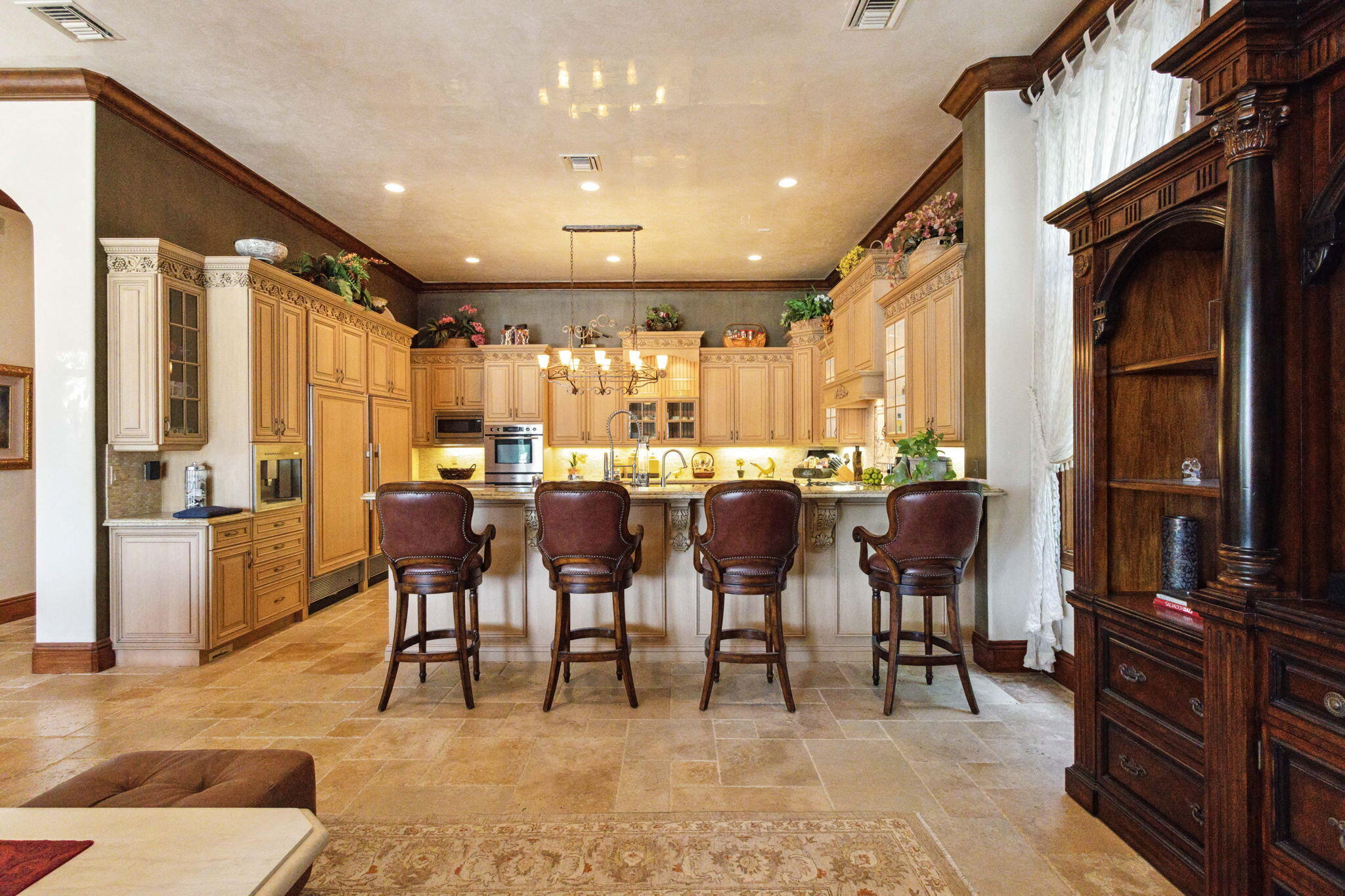 3870 Northeast 31st Avenue Lighthouse Point, FL 33064 - Photo 33 of 151 a group of people sitting in a living room with kitchen view and a chandelier