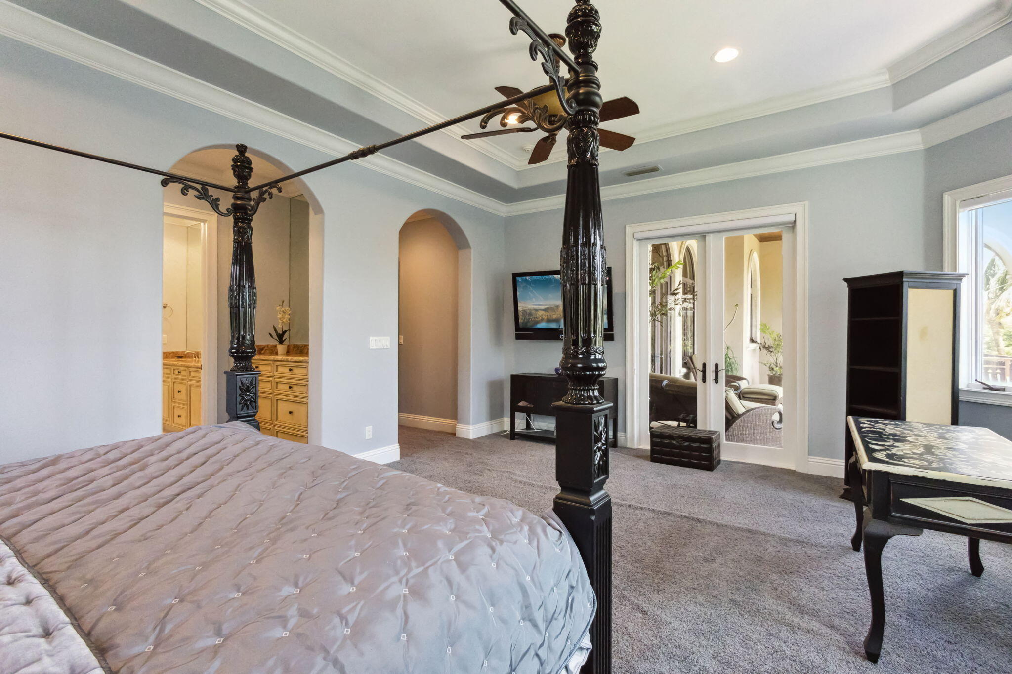 3870 Northeast 31st Avenue Lighthouse Point, FL 33064 - Photo 75 of 151 a bedroom with a bed couch and a chandelier
