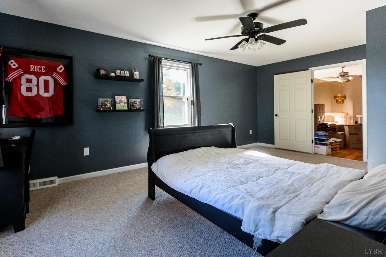 4945 Hixburg Road Pamplin, VA 23958 - Photo 11 of 27 a bedroom with a bed and a chandelier