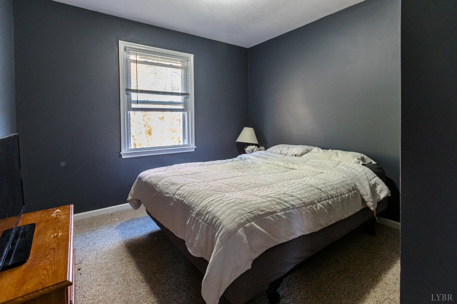 4945 Hixburg Road Pamplin, VA 23958 - Photo 13 of 27 a bedroom with a bed and window