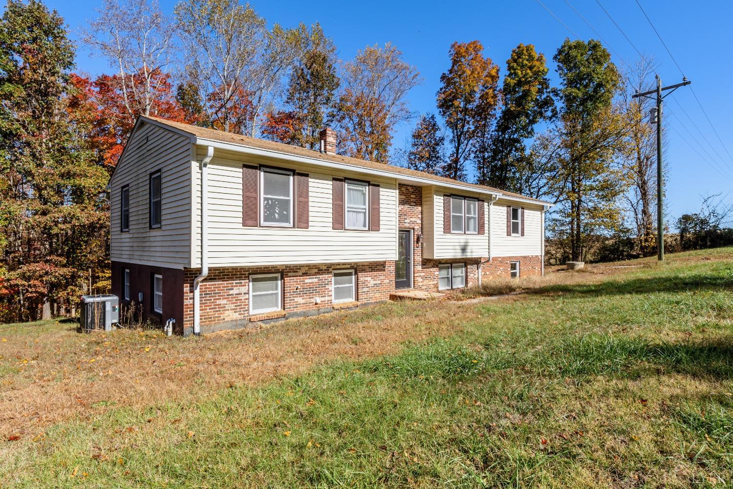 4945 Hixburg Road Pamplin, VA 23958 - Photo 2 of 27 a front view of a house with a yard and garage