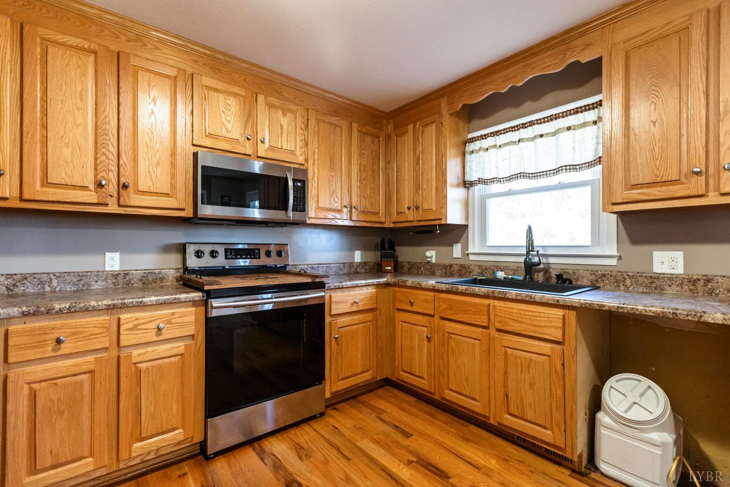 4945 Hixburg Road Pamplin, VA 23958 - Photo 6 of 27 a kitchen with granite countertop cabinets stainless steel appliances a window and a sink