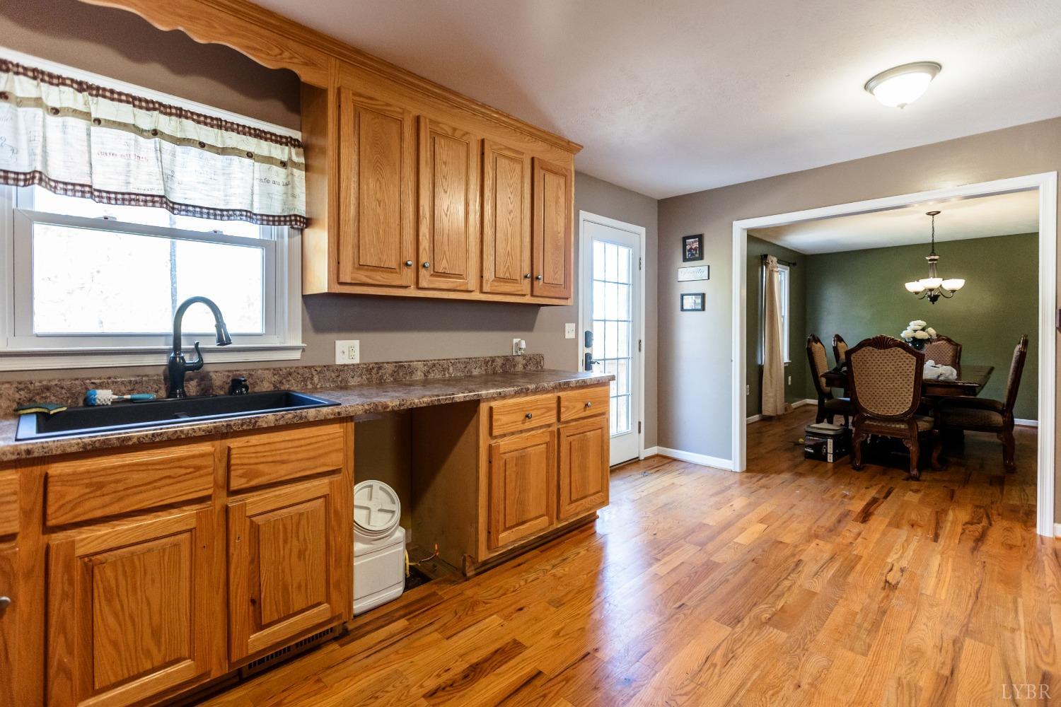 4945 Hixburg Road Pamplin, VA 23958 - Photo 8 of 27 a kitchen with wooden floors and wooden cabinets