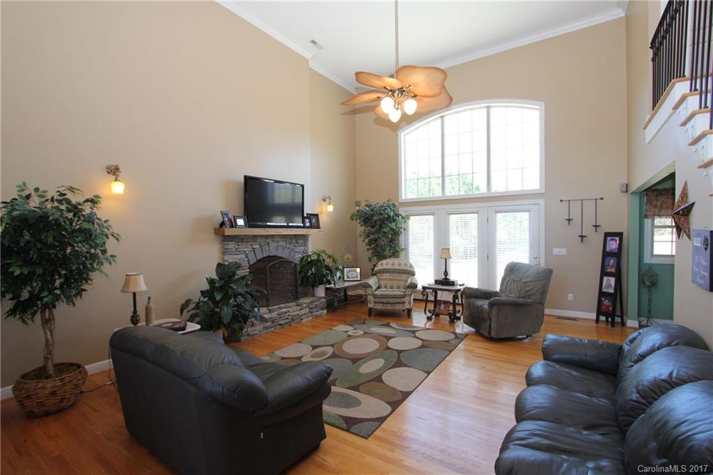 735 Faulkner Road Peachland, NC 28133 - Photo 4 of 24 a living room with furniture a large window and a fireplace