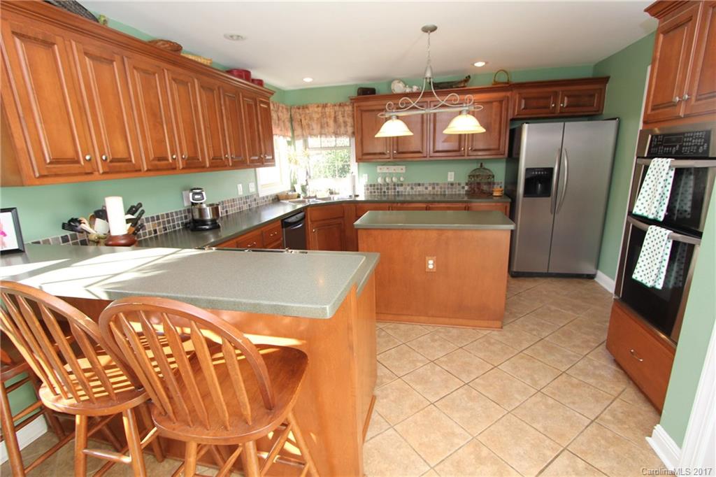 735 Faulkner Road Peachland, NC 28133 - Photo 5 of 24 a kitchen with stainless steel appliances granite countertop a refrigerator and a stove