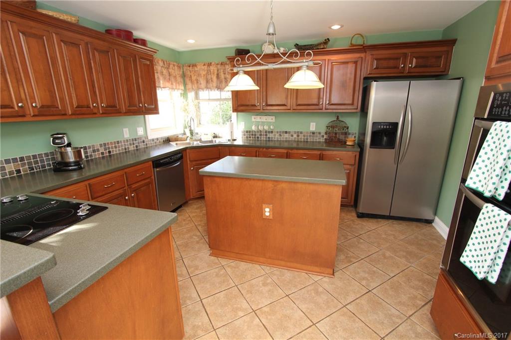 735 Faulkner Road Peachland, NC 28133 - Photo 6 of 24 a kitchen with stainless steel appliances granite countertop a refrigerator a sink and a stove