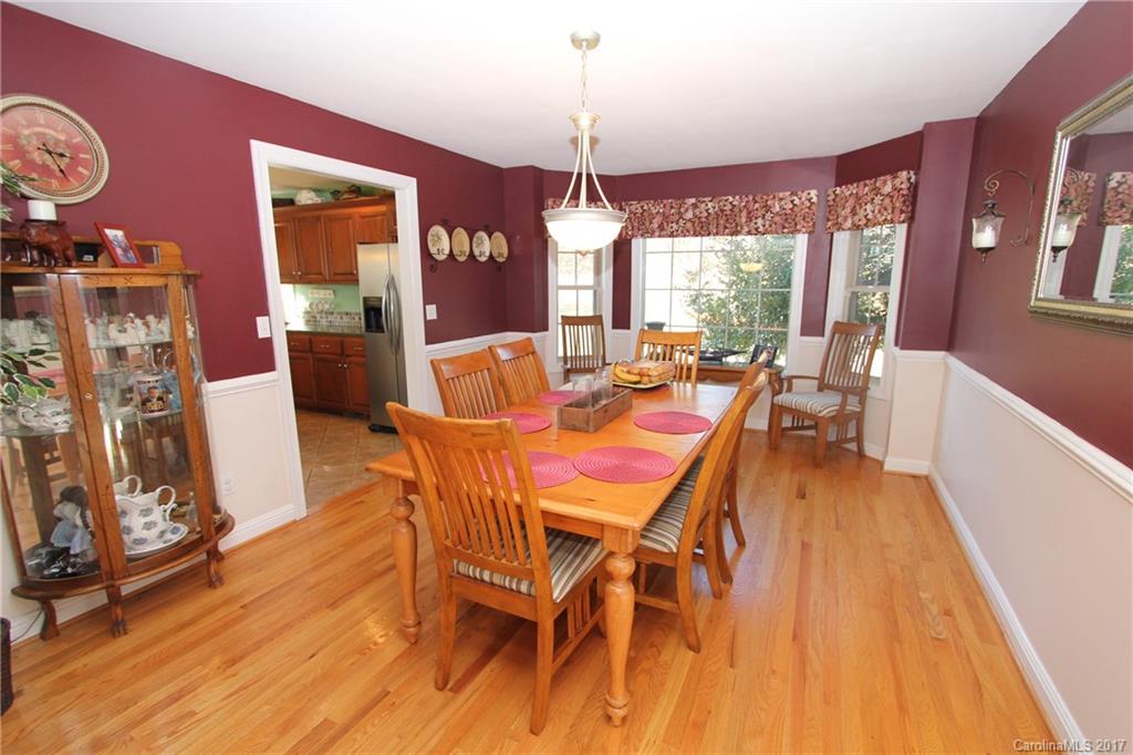 735 Faulkner Road Peachland, NC 28133 - Photo 8 of 24 a dining room with furniture a chandelier and wooden floor