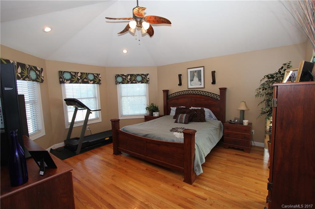 735 Faulkner Road Peachland, NC 28133 - Photo 10 of 24 a spacious bedroom with a bed and a flat tv screen on the dresser