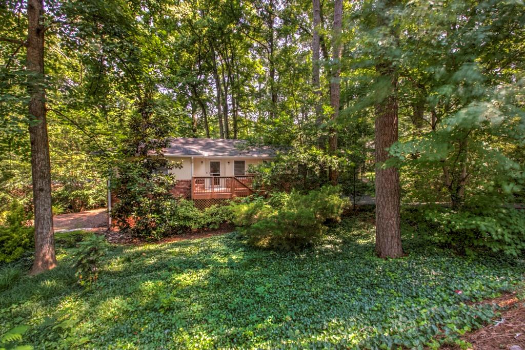 Natural stream-side setting with picturesque wood bridge. Spruell Springs Rd is 1 mile north of Chastain Park off Lake Forrest 
