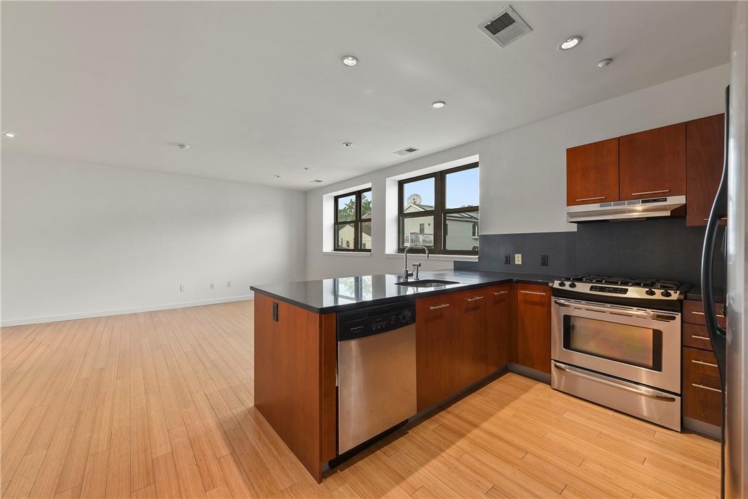 a kitchen with stainless steel appliances granite countertop a stove and a sink