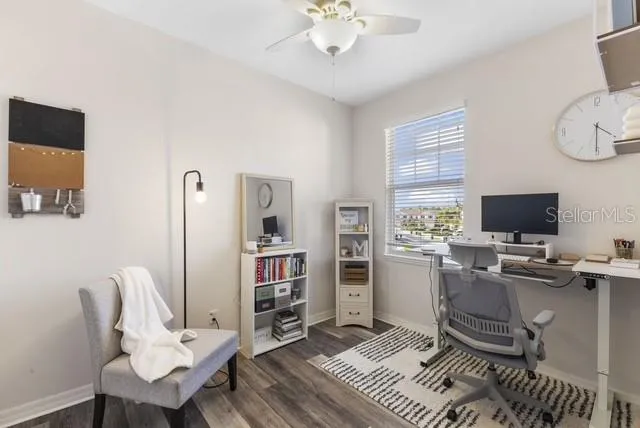 a view of a livingroom with workspace and a window
