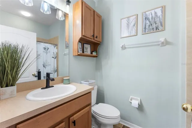 a bathroom with a sink a toilet and mirror