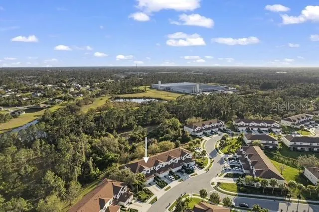 an aerial view of residential building with yard