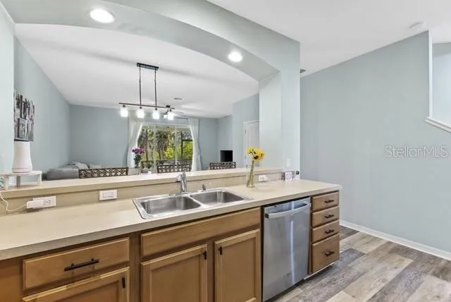 a kitchen with a sink and chandelier