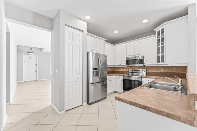 a kitchen with a sink stove and refrigerator