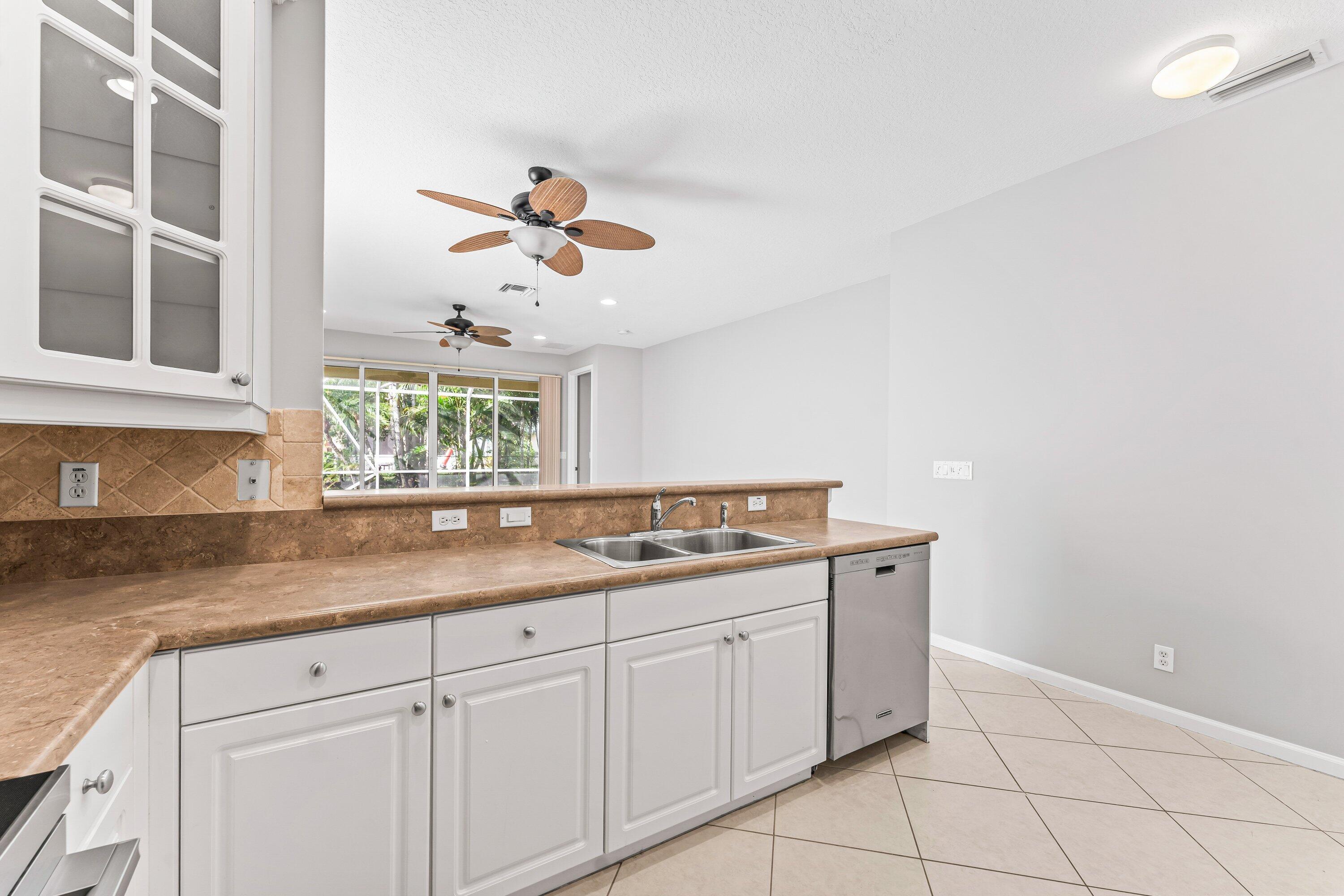 443 Belle Grove Lane West Palm Beach, FL 33411 - Photo 14 of 29 a kitchen with a cabinets and window