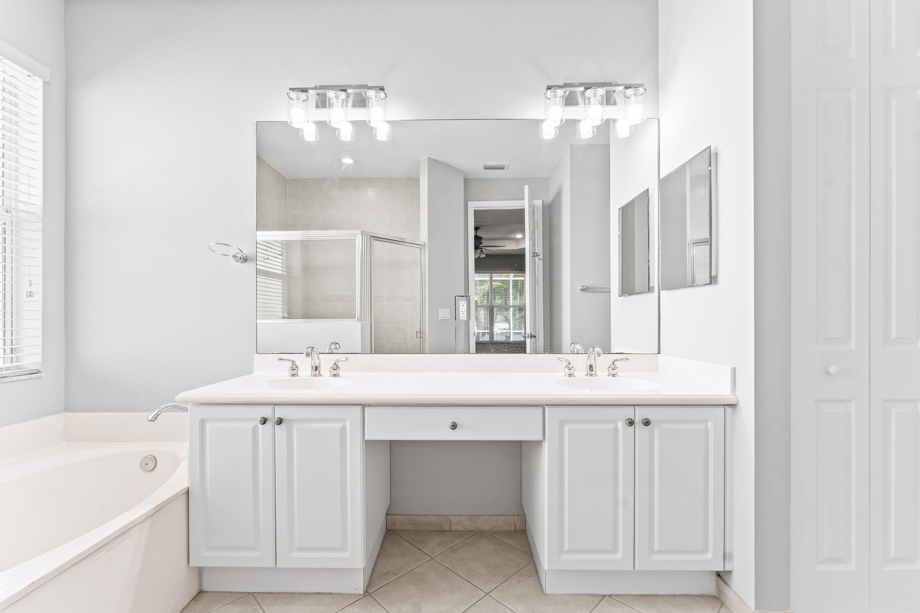 443 Belle Grove Lane West Palm Beach, FL 33411 - Photo 23 of 29 a bathroom with a double vanity sink mirror and bathtub