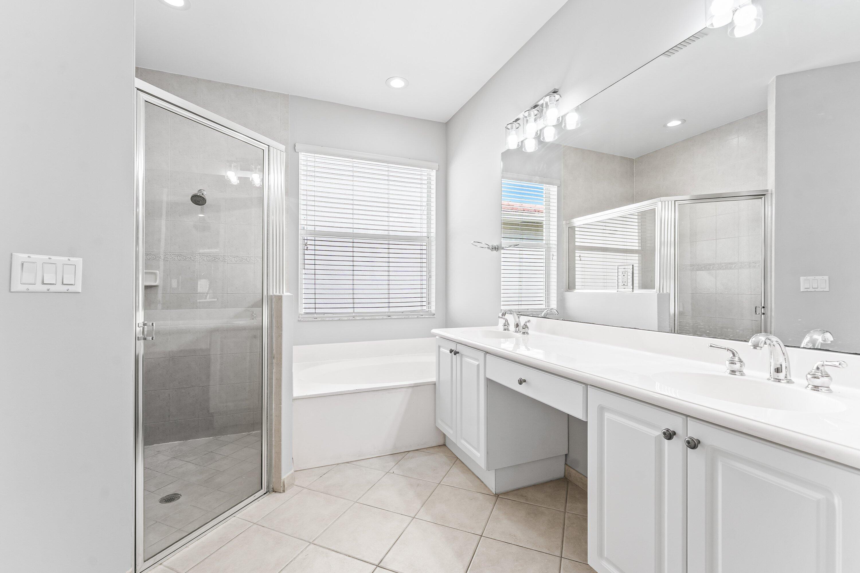 443 Belle Grove Lane West Palm Beach, FL 33411 - Photo 24 of 29 a bathroom with a tub sink shower and mirror