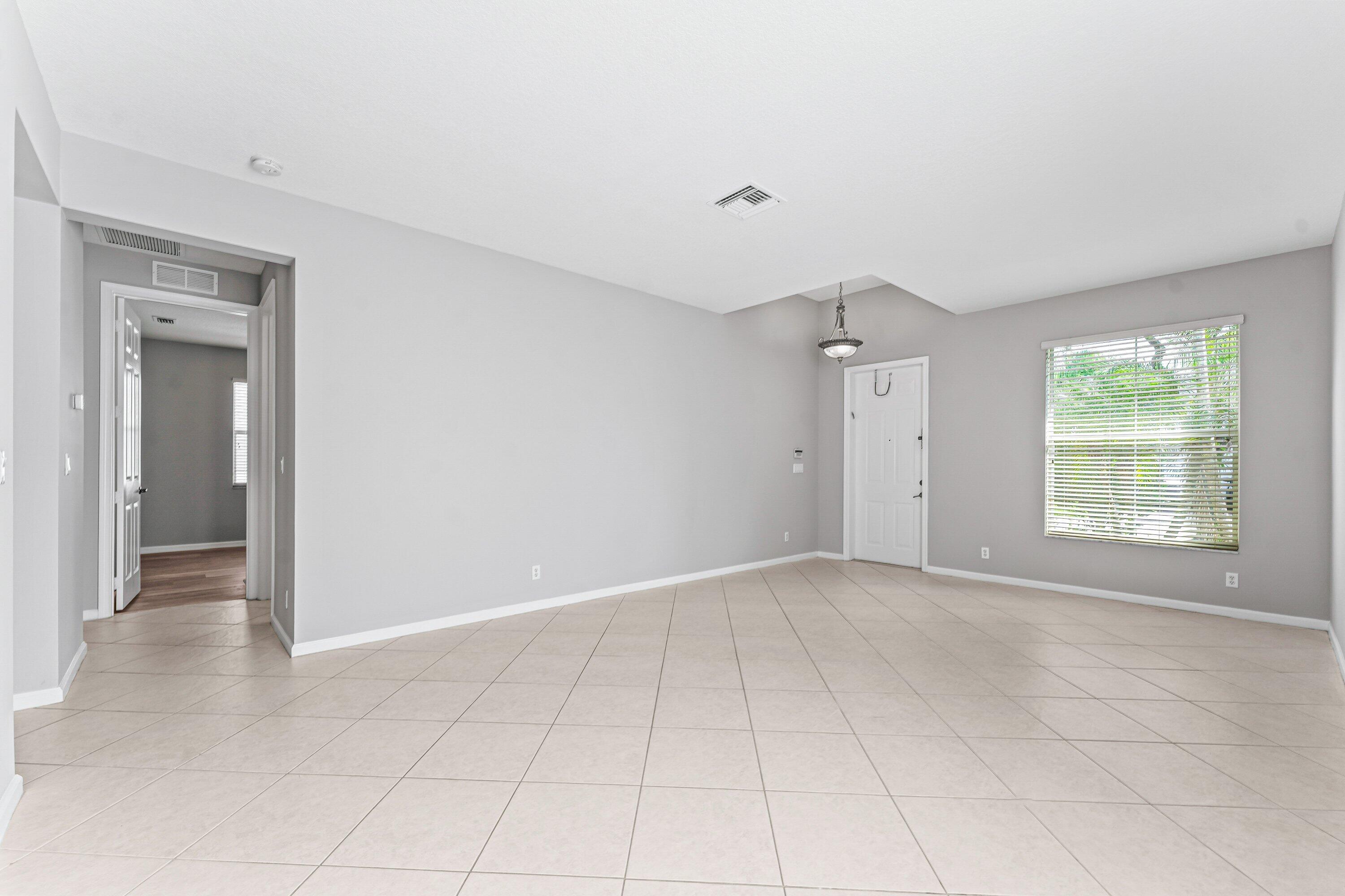 443 Belle Grove Lane West Palm Beach, FL 33411 - Photo 4 of 29 an empty room with windows and closet