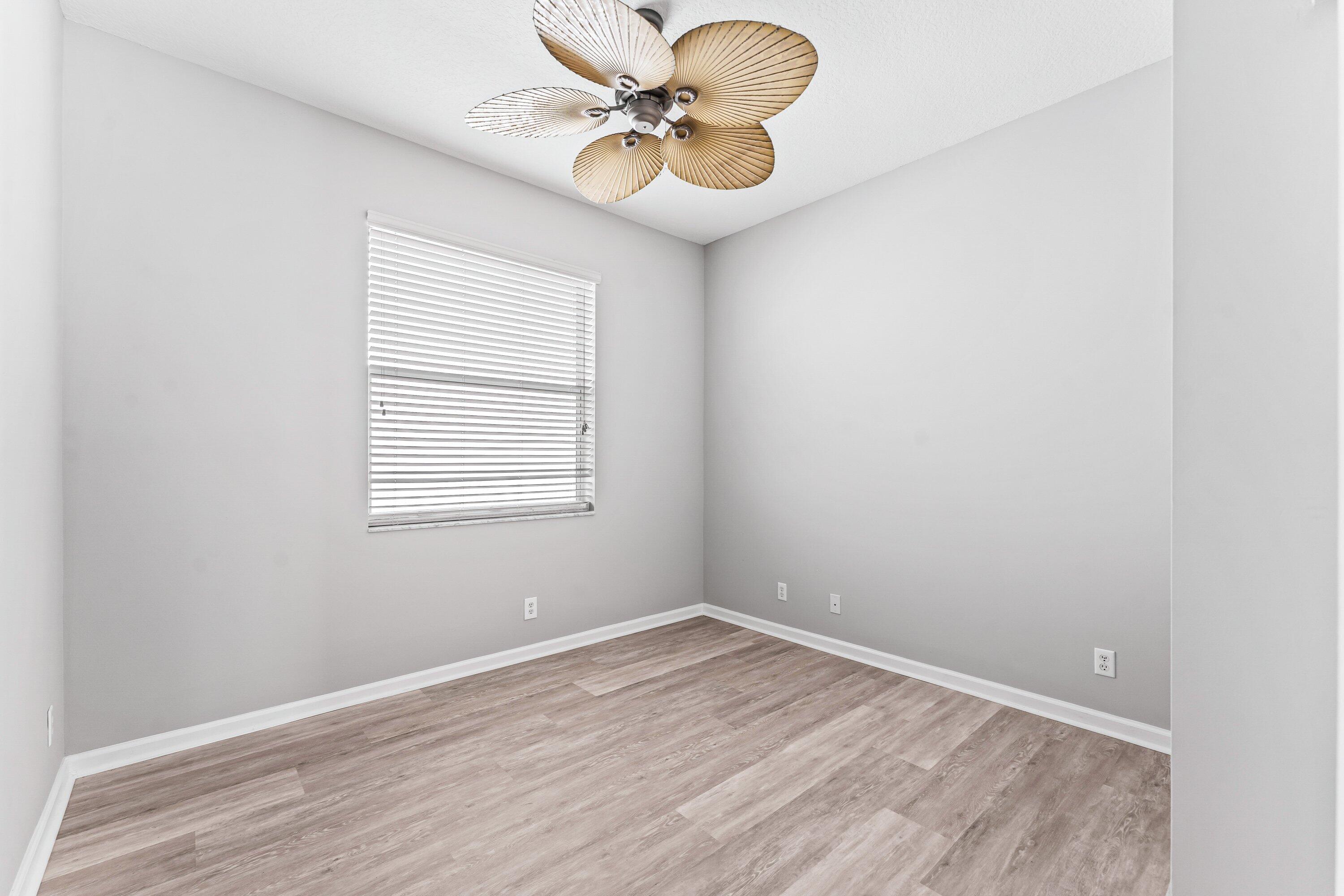 443 Belle Grove Lane West Palm Beach, FL 33411 - Photo 6 of 29 a view of a room with a window a ceiling fan and wooden floor