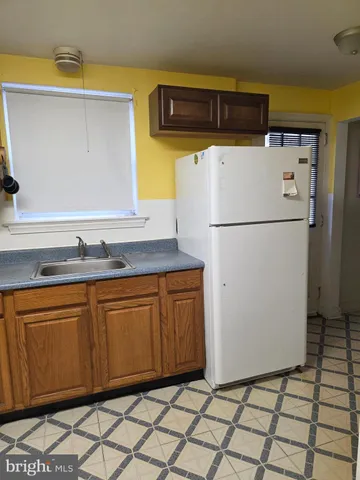 a white refrigerator freezer sitting inside of a kitchen