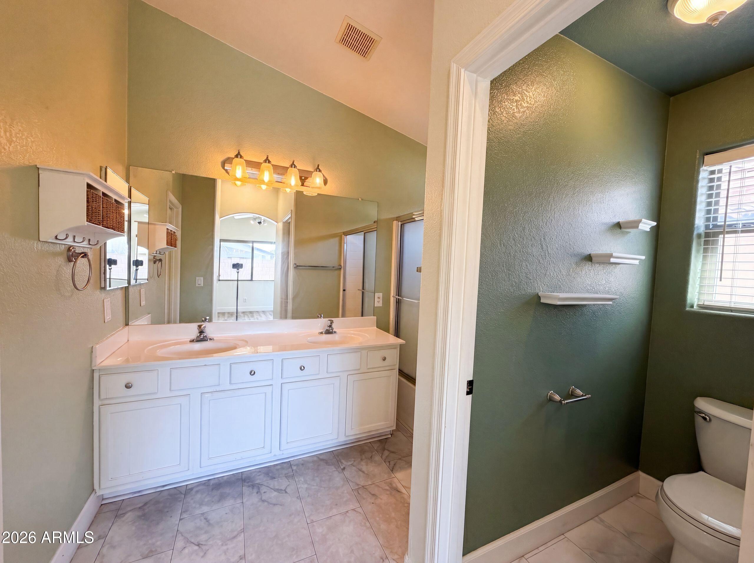 3951 East Timberline Road Gilbert, AZ 85297 - Photo 21 of 28 a bathroom with a double vanity sink toilet and a mirror