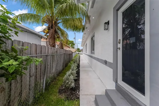 a backyard of a house with plants and entertaining space