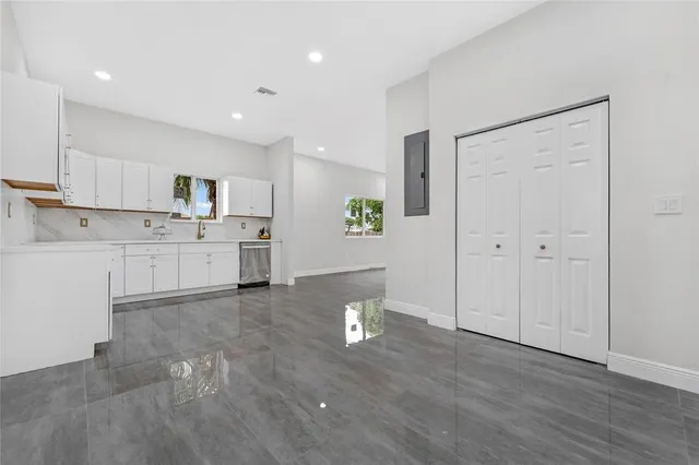 a view of a kitchen with wooden floor and electronic appliances