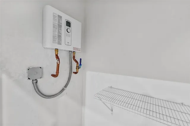 an empty room with wooden floor and window