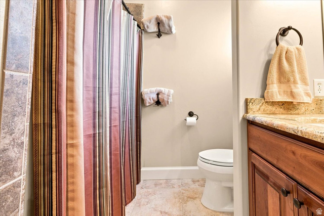 11290 South Southfield Road Mayfield, UT 84643 - Photo 73 of 103 Warm-toned vanity with stone countertop, tile flooring, and integrated toilet