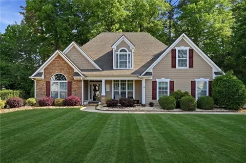 a front view of house with yard and green space