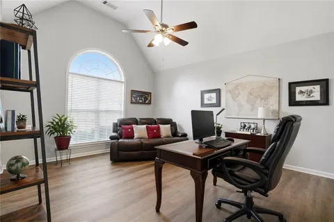 a work room with furniture and wooden floor