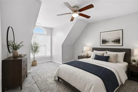 a bedroom with a large bed and a chandelier