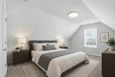a bedroom with a bed and a couch