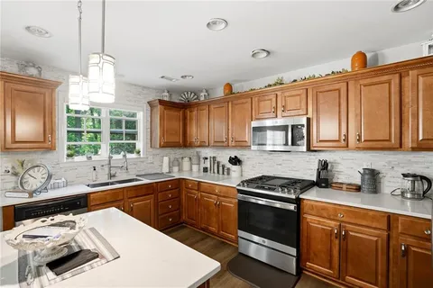 a kitchen that has a sink and a stove in it