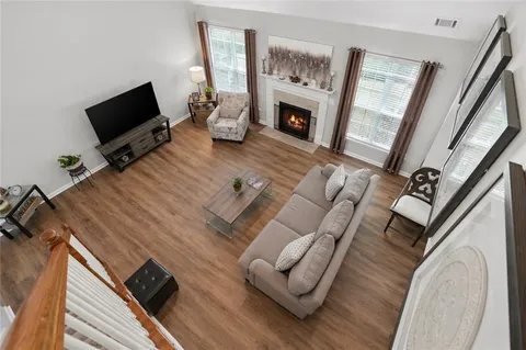 a living room with furniture fireplace and flat screen tv