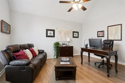 a living room with furniture and a wooden floor
