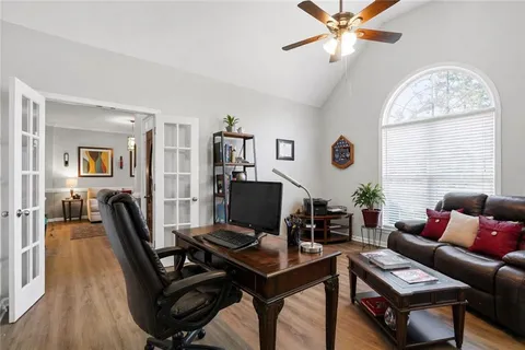 a living room with furniture a wooden floor and a window