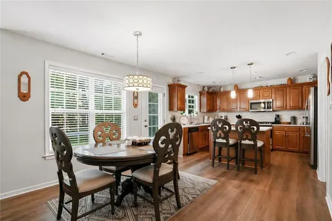 a view of a dining room with furniture and wooden floor