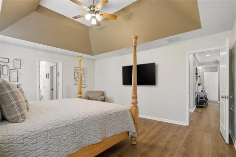 a bedroom with a bed and a chandelier
